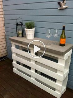 an outdoor bar made out of pallets and wine glasses