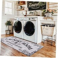 a washer and dryer sitting in a room next to a rug on the floor