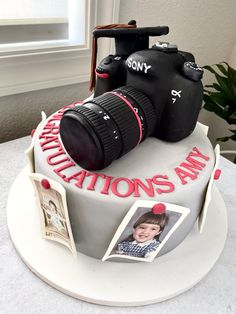 a birthday cake with a camera and photos on it