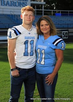 a man and woman standing on top of a football field