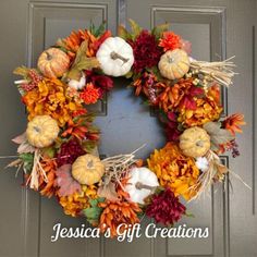 a wreath with pumpkins and gourds on it