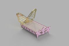 a pink and gold bed with a butterfly on it's headrest, sitting in front of a gray background