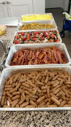 several trays filled with different types of food