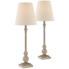 two lamps with white linen shades on each lamp and one is turned off to the side