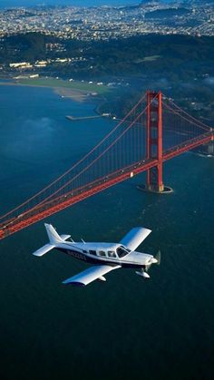 an airplane flying over the golden gate bridge