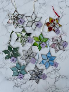 a marble table topped with lots of different colored ornaments