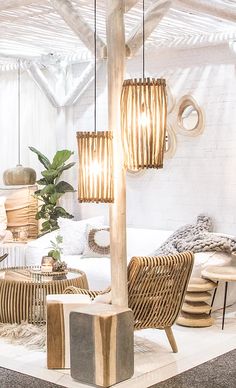 a living room filled with lots of furniture and decor on top of a white floor