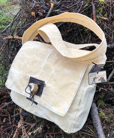 "This listing is for a made to order Bushcraft Bag in your choice of black, green, blue, brown or natural (white) canvas. Handmade in the Alaskan Outback from 100% , cotton duck canvas, heavily waxed for waterproofed durability. featuring oiled leather and aged tundra caribou antler details. It is built rugged and comfortable to carry with a 52\" strap that you can wear cross body. The strap is attached to the bag with leather straps for extra reinforcement. The strap is 2.5 inches wide and sturdy. The bag itself measures 14 \" across X 11\" height. The width of the bag 4\" for a roomy interior. The interior is made from cotton canvas with one smaller pocket on the inside. it also features an outside back pocket with a small leather pocket for your pocket knife to latch onto. My Kershaw po Outdoor Cotton Canvas Shoulder Bag, Rectangular Waxed Canvas Bag For Outdoor Activities, Canvas Satchel Bag For Outdoor Use, Cotton Bag With Waxed Finish For Outdoor Activities, Outdoor Cotton Canvas Bag With Adjustable Strap, Durable Canvas Shoulder Bag For Everyday Use, Practical Duck Canvas Bag For Outdoor, Practical Canvas Bag For Hiking, Waxed Cotton Bag