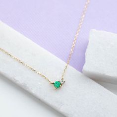 A dainty necklace in 14K gold with natural emerald and diamond in cluster set. This necklace is ideal as everyday jewelry and a great option for a birthday gift as emerald is May birthstone. D E T A I L S● Metal: 14K solid gold, 14K white gold or 14K rose gold● Gemstones: Emerald, round cut 3mm, Diamond, brilliant cut, 2mm● Gemstones Weight: 0.10 ct, 0.03 ct● Length: 40 cm - 16 inchesH O W ∙ T O ∙ O R D E RChoose from the drop-down menu the available options (Metal) and leave us a note for any s Dainty 14k Gold Emerald Necklace, Dainty Yellow Gold Emerald Necklace For Anniversary, Dainty 14k Gold Emerald Necklace For Anniversary, Everyday Yellow Gold Emerald Necklace For May Birthstone, Dainty Yellow Gold Emerald Necklace, Fine Jewelry 14k Gold Emerald Birthstone Necklace, Fine Jewelry Diamond Necklace For May Birthstone, 14k Gold Emerald Birthstone Necklace, Dainty 14k Gold Emerald Necklace Gift