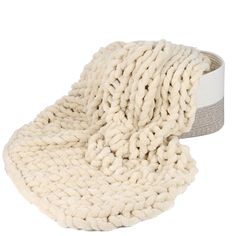 a white knitted blanket on top of a gray and white belt with a grey stripe down the middle