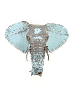 an elephant's head is painted blue and grey