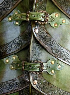 the back of a green leather jacket with gold rivets