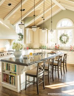 a large kitchen with an island in the middle