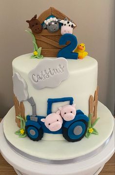 a three tiered cake with farm animals on it