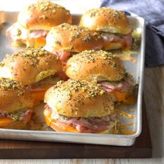 ham and cheese sliders with mustard sprinkled on them are ready to be eaten