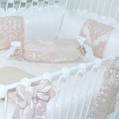 a baby crib with pink and white bedding