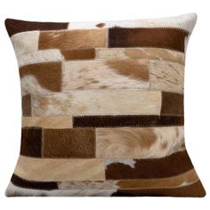 a brown and white cowhide pillow on a white background