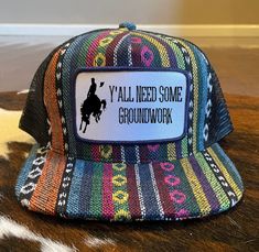 Y'all Need Some Groundwork Western Aztec Trucker Hat/Mesh Ball Cap Snap Back Closure Patch has design sublimated on and then patch is sewn onto the hat. Adult Size Measurements: 2.75'' Brim Length; 4.5''x7.0'' Crown Youth Size Measurements: 6.5'' x 2.5'' Brim; 7.5'' x 6.5'' Crown; 4'' High Multicolor Trucker Hat With Flat Bill, Multicolor Curved Bill Trucker Hat, Multicolor Flat Bill Trucker Hat, Country Style Baseball Cap For Western-themed Events, Multicolor Trucker Snapback Hat, Multicolor Trucker Snapback Baseball Cap, Multicolor Trucker Hat, Western Ball Caps, Trucker Cap For Rodeo, One Size Fits Most