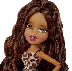 a close up of a doll with long brown hair and leopard print dress on it