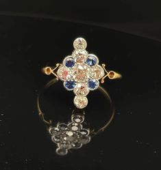 Very fine 18k gold, diamond, sapphire, cluster, ring from the 1920's. Crafted in 18j white and yellow gold. The ring is beautiful old cut gems from a London estate.  I bet the person who wore this really could  Charleston all night all.  Now it's your turn. Ring size 8.   Sapphires .40cttw Diamonds .1.50cttw Antique Yellow Gold Sapphire Ring With Rose Cut Diamonds, Antique Sapphire Diamond Ring With Rose Cut, Heirloom Sapphire Diamond Ring With Rose Cut, Vintage Multi-stone Diamond White Rings, Art Deco Gold Sapphire Ring With Rose Cut Diamonds, Victorian Multi-stone Yellow Gold Diamond Ring, Antique Yellow Gold Sapphire Ring With Single Cut Diamonds, Yellow Gold Sapphire Ring With Rose Cut Diamonds Cluster, Vintage Sapphire Diamond Ring With Rose Cut