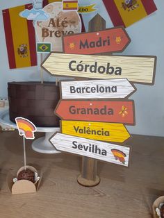 there are many wooden signs on the table in front of a cake with flags hanging from it