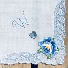 "You will buy a pretty, new and unused vintage, white and blue cotton, machine and hand embroidered hankie. This handkerchief would make an ideal \"Something Blue\" gift to give to a bride to be with the initial \"W\" on her special day. I have monogrammed this vintage hankie with the initial \"W\" in contrasting blue thread in one corner. The vintage handkerchief has a blue and yellow appliquéd flower underneath the \"W\" and a blue nylon edge. I have added a pretty blue mother of pearl heart s Classic Blue Cotton Handkerchiefs, Blue Embroidered Handkerchiefs For Wedding, Blue Embroidered Handkerchief For Wedding, Blue Embroidered Wedding Handkerchief, Vintage Blue Handkerchiefs For Wedding, Vintage Blue Wedding Handkerchiefs, Blue Vintage Wedding Handkerchiefs, Classic Blue Handkerchiefs For Gift, Blue Embroidered Handkerchiefs For Gifts