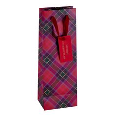 a red and black plaid paper bag with a bow