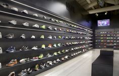 there are many pairs of shoes on display in the shoe store's showroom