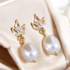 ✨ Attention: Elevate your elegance with our stunning Sterling Silver & Gold Pearl Diamond Earrings! Designed to captivate, these earrings combine the timeless beauty of real freshwater pearls and sparkling diamonds with a unique leaf design--perfect for brides or as a luxurious gift. 🌿💎 🌟 Interest: Handcrafted with precision, these earrings offer a delicate balance of sterling silver and gold accents, making them versatile for any occasion. Whether you're walking down the aisle or adding a to White Crystal Earrings With Elegant Design For Gift, White Crystal Earrings With Elegant Design For Anniversary, Classic White Flower Earrings For Wedding, Classic White Flower Wedding Earrings, Elegant Teardrop Flower Earrings For Jewelry Making, White Teardrop Earrings With Elegant Design For Gifts, Pearl Diamond Earrings, Pearl And Diamond Earrings, Gold Diamond Earrings