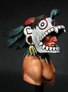 a man wearing a mask with feathers on it's head and one eye open