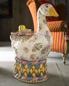 a ceramic duck sitting on top of a chair