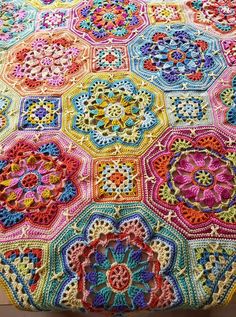 a crocheted blanket with many different colors on it