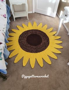 a crocheted sunflower rug on the floor in a child's bedroom