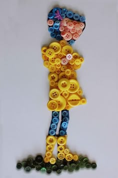 a person made out of buttons on a white surface