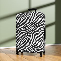 Luggage is expensive, and they aren't always treated with care.  So why not protect your investment with our wild black and white zebra luggage cover!  Our cover not only adds a touch of wild flair to your bags but prolongs the life of your suitcase by shielding them from scratches, scuffs, and unexpected travel mishaps. You will have no trouble spotting this trendy zebra-inspired luggage cover at the baggage carousel!  Makes a wonderful gift for travel-loving friends or family. But it's not all about looks; its about substance too!  Crafted from durable, very stretchy high-quality material, our unique luggage cover is designed to securely fit most standard suitcase sizes.  Plus, its quick and easy to install and remove by way of a top opening for the pull handle, an opening on the left fo Black Cases With Luggage Sleeve For Trip, Black Travel Cases With Luggage Sleeve, Black Rectangular Cases For Overnight Trips, White Suitcase, Honeymoon Clothes, Unique Luggage, Baggage Carousel, Suitcase Sizes, Honeymoon Outfits