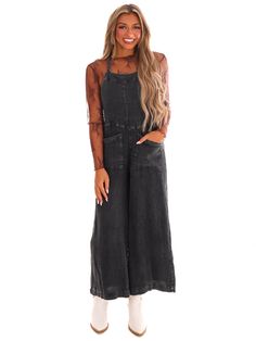 Get ready to rock those vintage vibes with our Mineral Wash Jumpsuit! Featuring slouchy, wide legs and a square neckline, this jumpsuit is effortlessly chic. It also includes front pockets, adjustable straps, and a back tie detail for added convenience. The textured fabrication adds a unique touch to this must-have piece. Black Jumpsuits And Rompers With Side Pockets For Summer, Black Summer Jumpsuits And Rompers With Bib Front, Black Summer Jumpsuit With Bib Front, Black Summer Overalls With Adjustable Straps, Black Bib Front Jumpsuit For Summer, Black Bib Front Jumpsuits And Rompers For Summer, Chic Black Denim Jumpsuit With Pockets, Black Jumpsuits And Rompers With Side Pockets For Spring, Black Overalls With Adjustable Straps For Summer