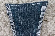 a piece of blue and white fabric with fringes on it