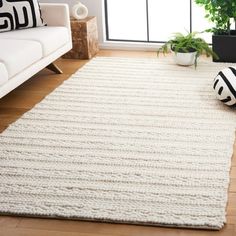 a living room with a white rug on the floor