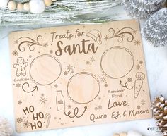 a wooden sign that says treats for santa and other holiday items around it on a table