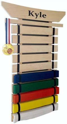 the kyle martial belt is stacked on top of each other and has an award medal