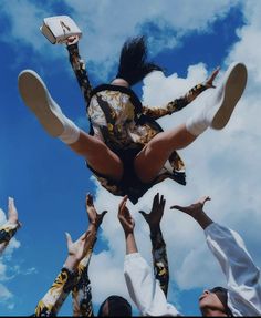 a group of people reaching up into the air