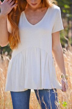 $29.00 Meet your new favorite tee with a twist! The flowy bottom and curved seam make it ultra-flattering and playful! As if it couldn’t get any better, it is SO soft, cool, stretchy, and opaque — it's basically perfect! Soft-washed Tops For Spring Day Out, Cream Solid Color Top For Spring, Effortless Spring T-shirt For Layering, Flowy Short Sleeve Tops For Fall, Effortless Short Sleeve Tops For Fall, Solid Short Sleeve Flowy Tops, Flowy Solid Color Short Sleeve Tops, Beige Solid Color Top For Day Out, Flowy Casual Tops For Day Out