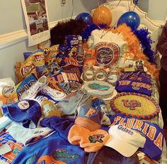 a bed covered in lots of sports memorabilia and balloons on top of it's head