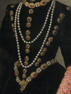 an elaborate necklace and earring set is displayed on a mannequin's chest