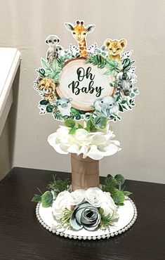 a baby's first birthday cake with flowers and giraffes on it