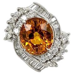 Simply Beautiful! Chic and Classic finely detailed Oval Strong Orange Sapphire and Diamond Platinum Cocktail Ring. Centering a securely nestled Hand set 6.46 Carat Fabulous Oval Strong Orange Sapphire surrounded by Diamonds, weighing approx. 1.16tcw. Shank Stamped Pt850 D1.16 S6.89(center known weight is now 6.46ct) Carte Blu Certification: Natural Sapphire heated. The ring is Hand crafted in Platinum. Size 6.75, we offer ring re-sizing. Ideal worn alone or as an alternative Engagement ring. In Luxury Orange Sapphire Ring For Anniversary, Orange Gemstone Ring, Orange Mermaid, Precious Stones Rings, Mermaid Ring, Alternative Engagement Ring, Orange Sapphire, Alternative Engagement Rings, Natural Sapphire