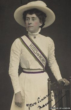 an old black and white photo of a woman wearing a hat