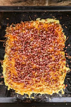 an uncooked pizza sitting on top of a pan covered in cheese and other toppings