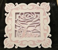 a white frame with a pink rose in the center and an inscription that says sister