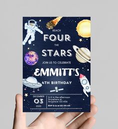 a hand holding up a birthday card with space and stars on it